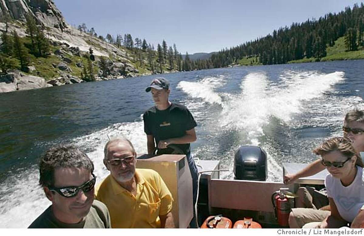 desolation014_lm.JPG Event on 7/10/05 in Desolation Wilderness. Bryan Clevenger, 19, standing, drives the boat taxi across Echo Lake. He has been working at the lake for 5 years. Liz Mangelsdorf / The Chronicle MANDATORY CREDIT FOR PHOTOG AND SF CHRONICLE/ -MAGS OUT