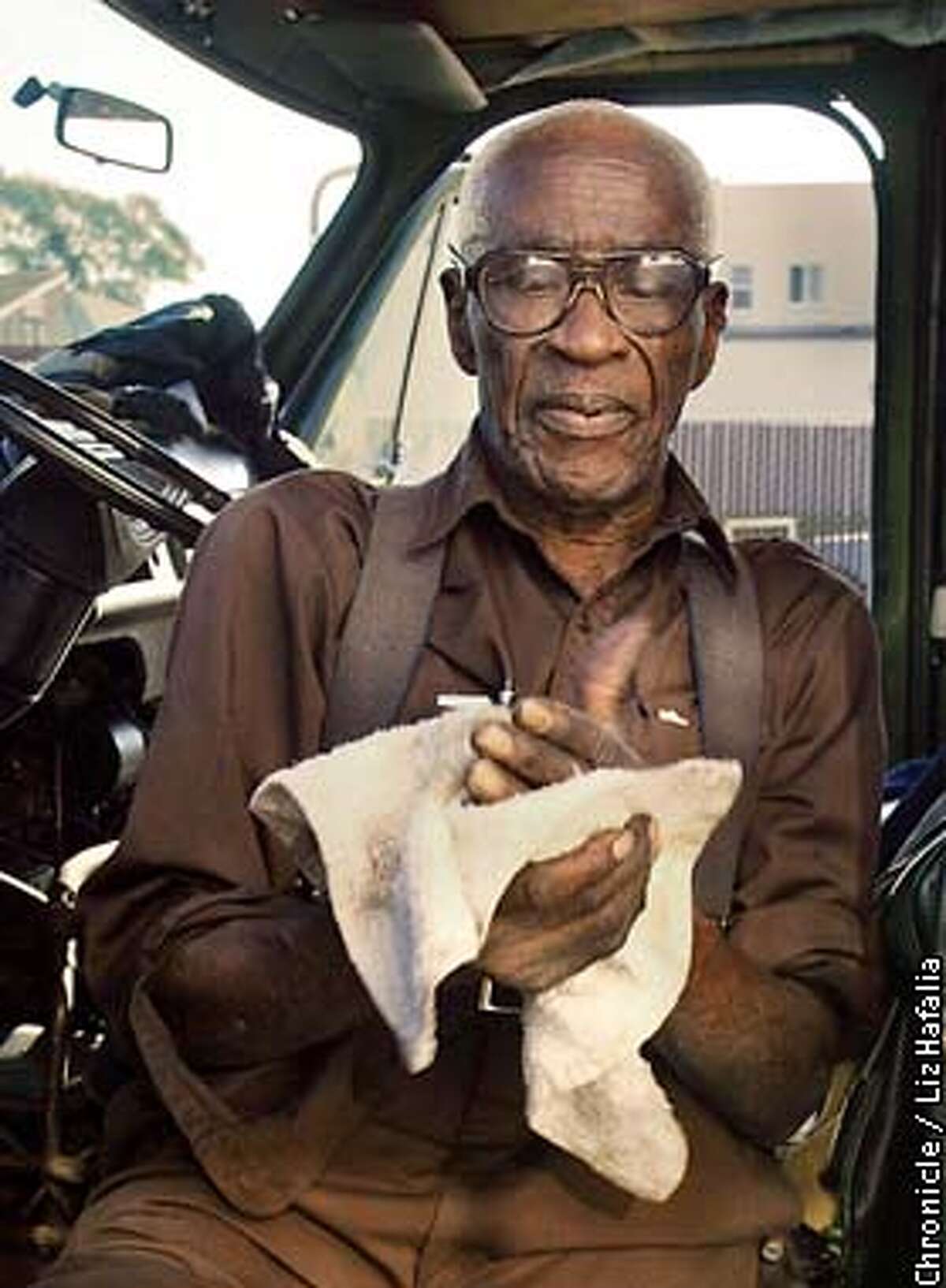Hillary Luckett, 86 years old, has had his carwash since 1961. He now has a partner who runs an auto mechanic shop on his property. He is wiping his hands after fixing the engine in his van. (PHOTOGRAPHED BY LIZ HAFALIA/THE SAN FRANCISCO CHRONICLE)
