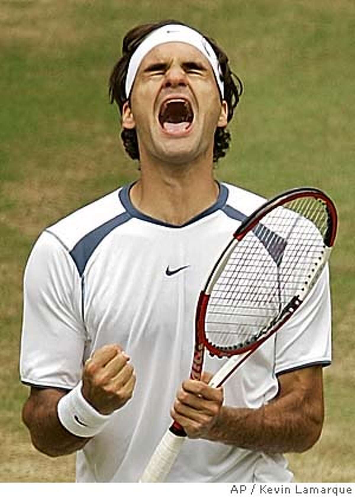 Defending champion Roger Federer reacts as he defeats Andy Roddick to win the Men's Singles final on the Centre Court at Wimbledon, Sunday June 3, 2005.(AP Photo/Kevin Lamarque, pool) POOL