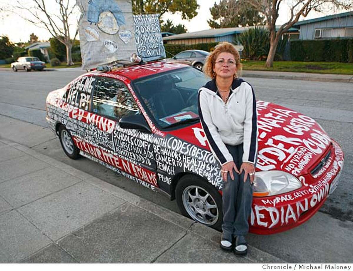 Estrella Benavides and her red Honda. Estrella Benavides of San Mateo is in trouble with the city of San Mateo for painting religious slogans all over her house and car. Benavidas of 1864 Cottage Avenue is violating the city's municipal code. Photo taken on 1/8/07 by Michael Maloney / San Francisco Chronicle
