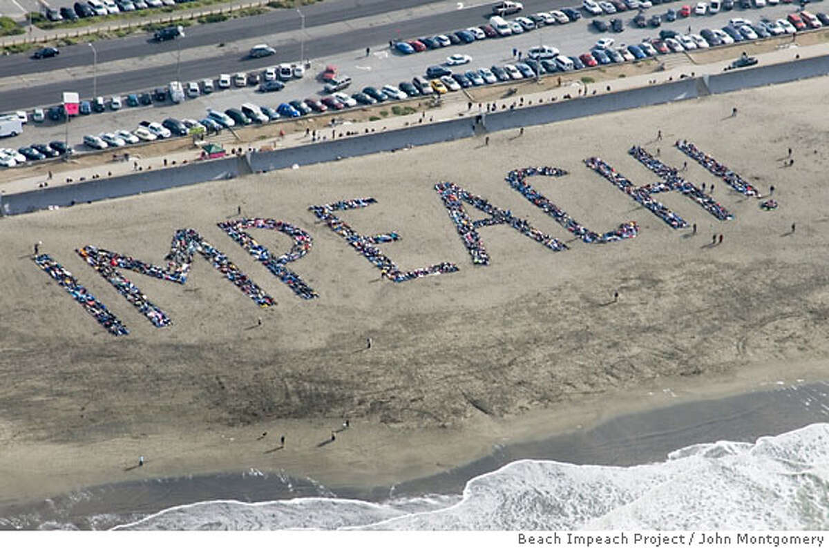 Volunteers gathered on Saturday Jan. 6, 2007 to form 100-foot letters stretching 450 feet across the sand on Ocean Beach in San Francisco to spell the word "impeach" for the benefit of aerial travelers. The Beach Impeach Project was organized by activist Brad Newsham. 2007 HANDOUT PHOTO BY JOHN MONTGOMERY/BEACH IMPEACH PROJECT