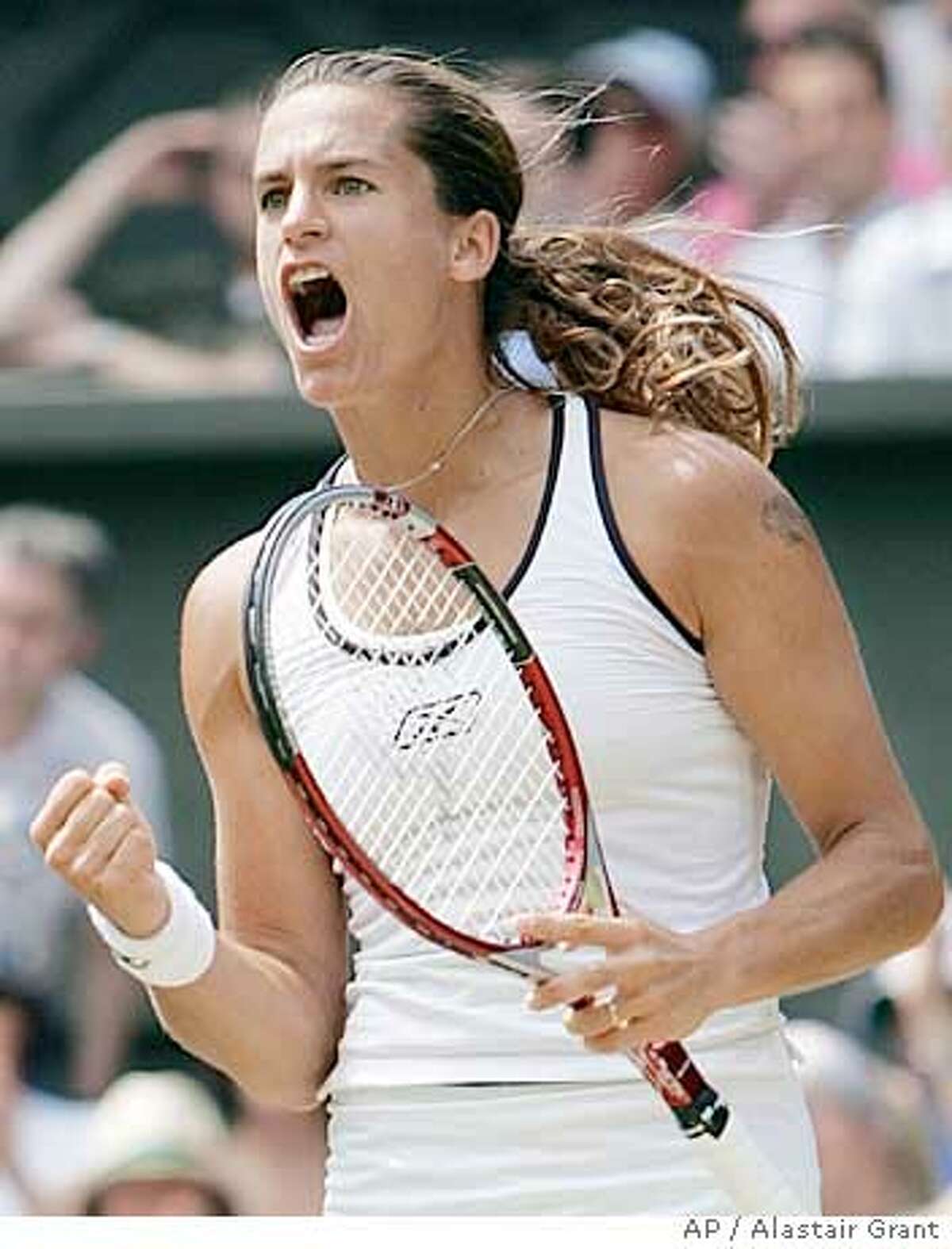 France's Amelie Mauresmo punches the air as she defeats Anastasia Myskina of Russia in their Women's Singles quarter-final match on the Centre Court at Wimbledon, Tuesday June 28, 2005. Mauresmo won the match 6-3, 6-4 to reach the semi-finals of the tournament.(AP Photo/Alastair Grant)