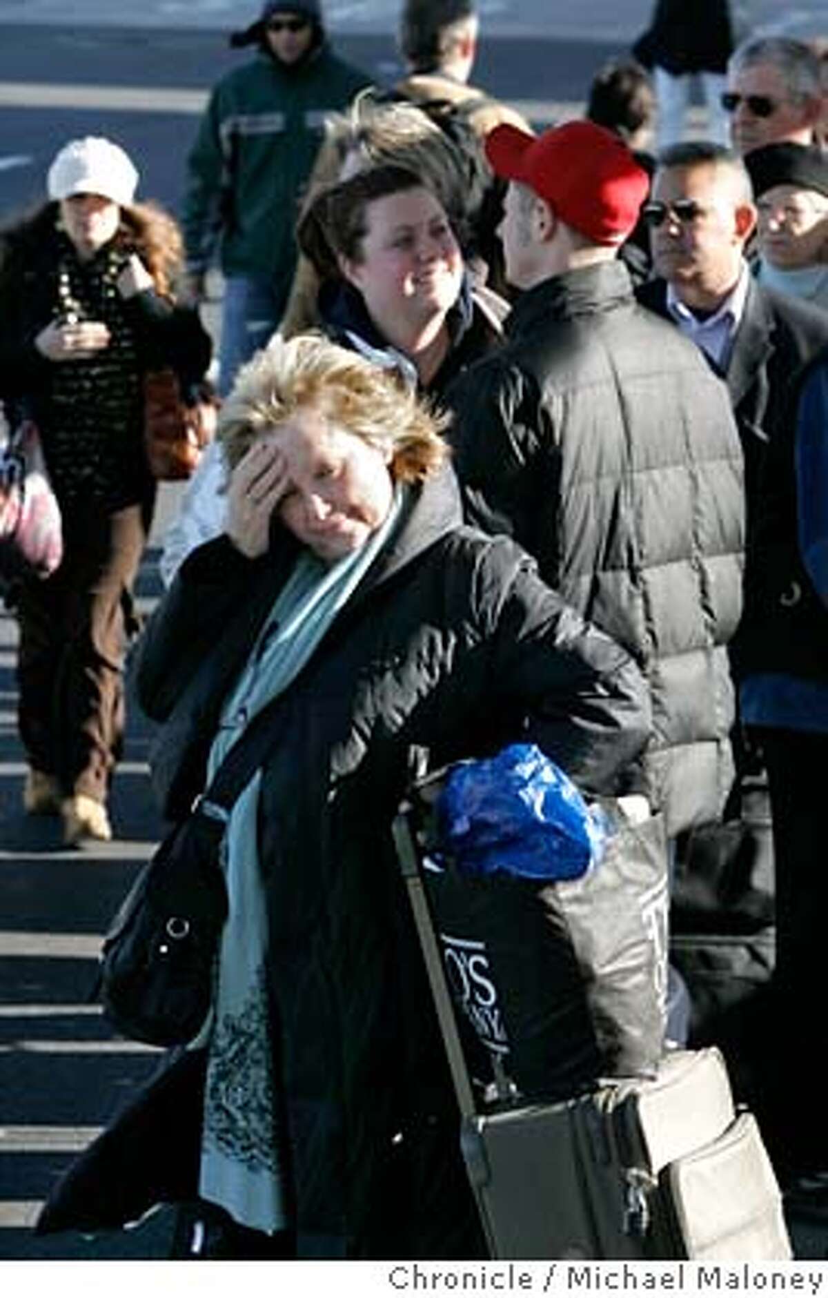 A frustrated Esther Benton of Los Angeles, waits in line for the rental car bus. Dozens of flights out of Oakland International Airport were delayed Friday afternoon after a man bolted past law enforcement and into the secure area of the airport, causing authorities to evacuate one terminal for two hours and the entire facility for about an hour, officials said. By 1 p.m., the airport was reopened and flights were beginning to take off again leaving huge lines as passengers needed to be re-screened. Photo taken on 1/5/07 by Michael Maloney / San Francisco Chronicle
