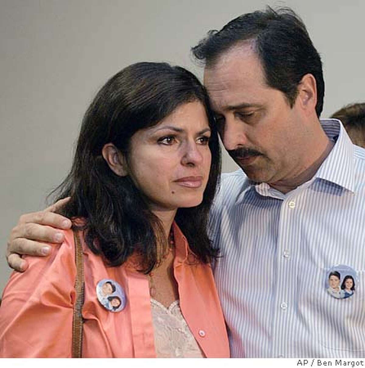 Bob Pack embraces his wife Carmen after emerging from a courtroom Friday, June 24, 2005, in Martinez, Calif. Nanny Jimena Barreto was sentenced Friday to 30 years to life in prison after being convicted last month of murder in the hit-and-run deaths of the Pack's two children. Barreto, 46, got down on her knees and sobbed as she read a two-page letter expressing her remorse for the deaths of Troy Pack, 10, and his sister, Alana, 7. The children were riding a scooter and a bike on their way to get Slurpees with their mother and friends. (AP Photo/Ben Margot)