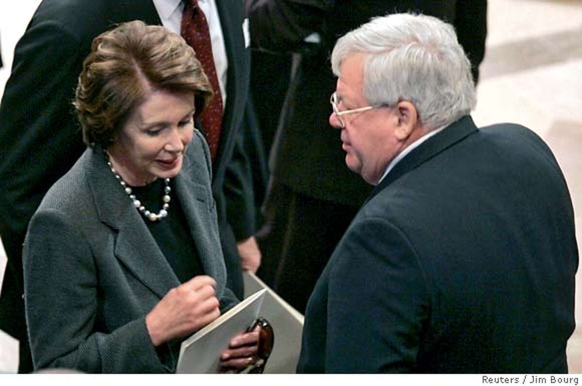 Speaker-elect Nancy Pelosi (L) (D-CA) talks with Speaker of the House Dennis Hastert (R-IL) before the funeral of former U.S. President Gerald Ford at the National Cathedral in Washington, January 2, 2007. REUTERS/Jim Bourg (UNITED STATES) 0