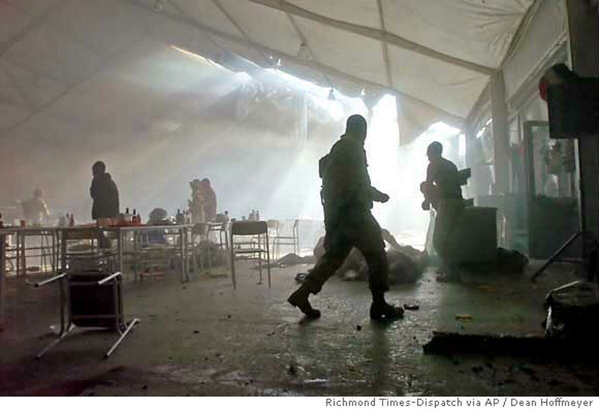 A haze of smoke a from an apparent insurgent mortar attack clouds a dining facility moments after the blast on FOB Marez in Mosul, Iraq on Tuesday, Dec. 21, 2004. At least one U.S. soldier was killed. (Richmond Times-Dispatch / Dean Hoffmeyer)