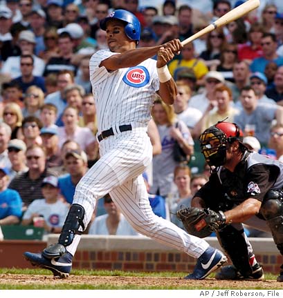 Chicago Cubs' Moises Alou hits a home run in the third inning against the  Cincinnati Reds, Friday, April 16, 2004 in Chicago. Later Alou hit a  walk-off home run in the bottom