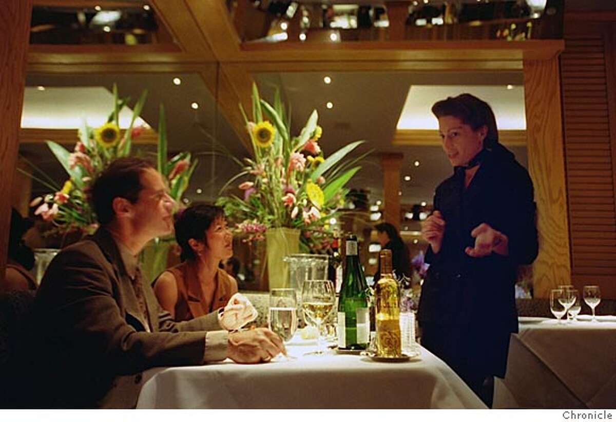 DANKO25A-C-22AUG99-FD-RW Pete Perry and his wife Toni Morozumi, left, chat with Renee-Nicole Kubin, the wine director, during dinner at Gary Danko at 800 North Point at Hyde near Fisherman's Wharf in San Francisco. BY ROBIN WEINER/THE CHRONICLE