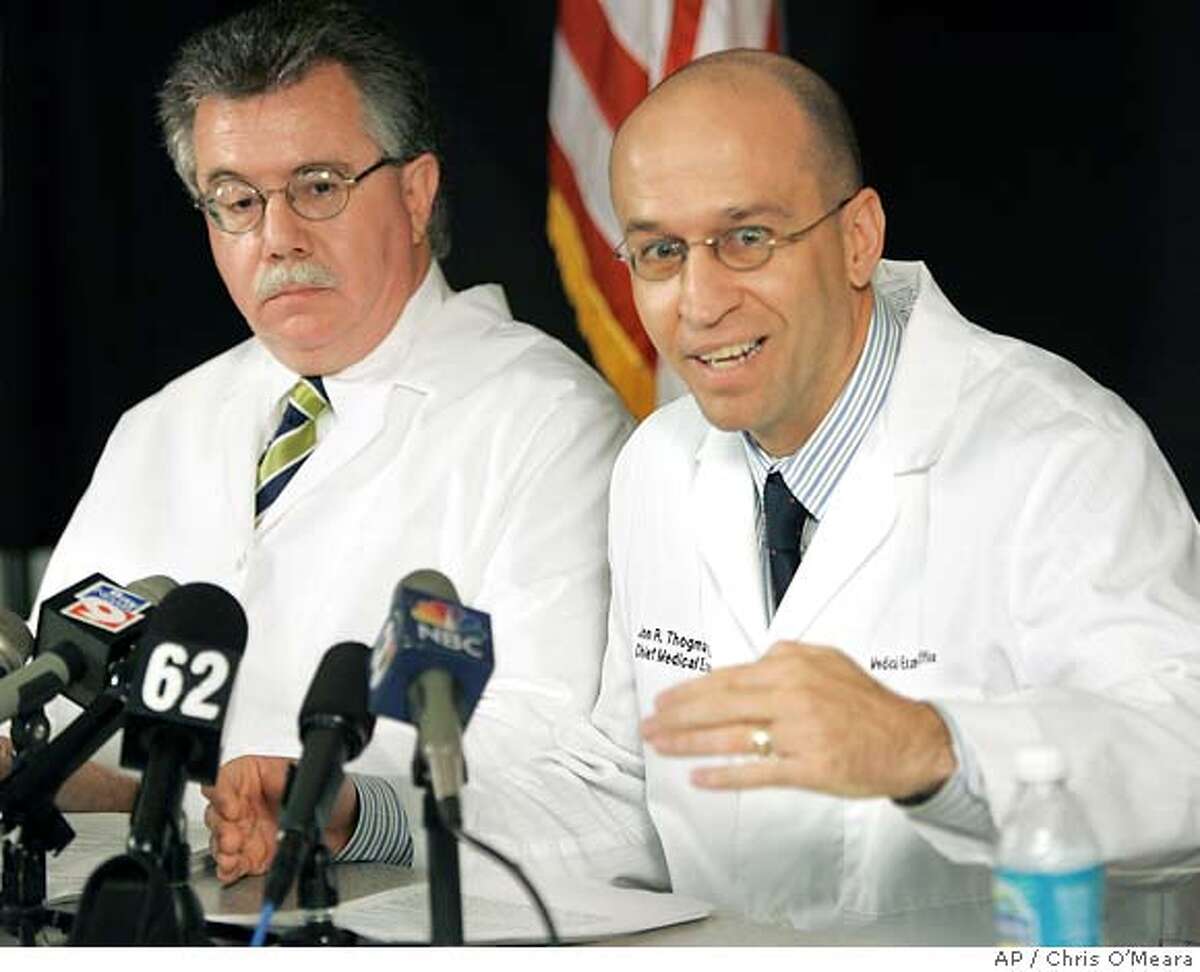 Dr. Jon Thogmartin, right, District 6 Medical Examiner, gestures as he gives a report with Dr. Stephen Nelson on Terri Schiavo's autopsy during a news conference Wednesday, June 15, 2005, in Clearwater, Fla. Schiavo's autopsy backed her husband's contention that she was in a persistent vegetative state, finding that she had massive and irreversible brain damage and was blind, the medical examiner's office said Wednesday. It also found no evidence that she was strangled or otherwise abused. (AP Photo/Chris O'Meara)