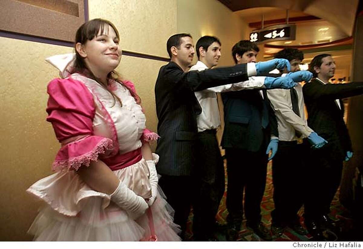 SERENITY_010_LH.JPG Arielle Kesweder's (left, from San Leandro) mom, Rebecca Kesweder made the dress. She's dressing up as Kayle, a character from Firefly TV show. At right from left to right with blue gloves are Ramzi Kawar, Chris Mogannam, Anthony Mogannam, Alan Saade, and Joey Saade, all from San Jose, in the beginning of the line waiting since 4:00pm. They're dressing as "blue-handed bad guys'' from the show. In 2002, a series called "Firefly" -- created by Joss Whedon of "Buffy the Vampire Slayer" and "Angel" fame -- aired on the FOX Network. Whedon made a movie, "Serenity," based on the short-lived series, and has scheduled sneak previews of the unfinished cut ("Serenity" isn't out until Sept.) across the country. Preview screenings at AMC/Van Ness have sold out in minutes. Shot in San Francisco on 5/26/05. In case of name discripancy with story, go with story in this case. Creditted to San Francisco Chronicle/Liz Hafalia