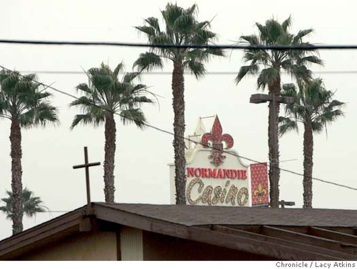The Normandy Casino loomes over the treetops and the roof of the Chuch of the Holy Communion that sits behing the Casino, in Gardena.The Normandy Casino sits in the middle of business, houses and the Church of Holy Communion, Dec. 8, 2004, in Gardena. The working class city of Gardena , in south Los Angeles is drowning in debt and has become heavily dependent on the Hustler Casino and the Normandy Casino to bring in revenue, Dec. 8, 2004. LACY ATKINS/SAN FRANCISCO CHRONICLE