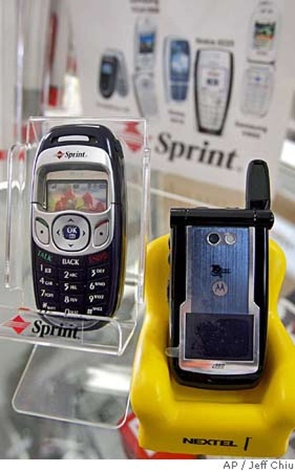 The Sprint LGPM325, left, and the Nextel Motorola i860 phones are shown at People's Wireless in San Francisco, Wednesday, Dec. 15, 2004. The $35 billion merger of Sprint Corp. and Nextel Communications Inc. could challenge Cingular Wireless and Verizon Wireless for supremacy in a ruthlessly competitive business where prices are constantly dropping. The merger, if approved, would create a company called Sprint Nextel with 35 million wireless subscribers and a combined $40 billion in annual revenue, cementing Sprint's spot as the country's third largest wireless business after Cingular and Verizon. (AP Photo/Jeff Chiu)