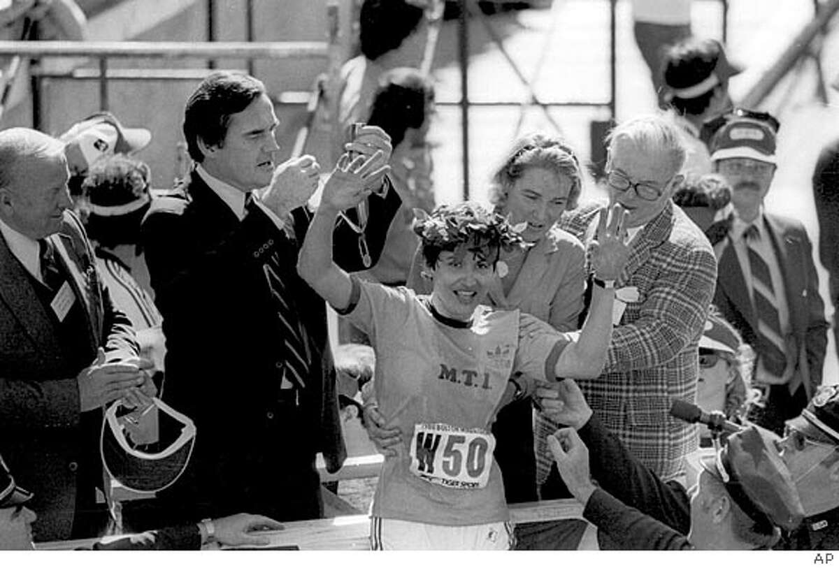 Rosie Ruiz, of New York, waves to the crowd after receiving the laurel wreath from the wife of Boston's mayor, Katherine White after she was announced as winner of the women's division of the Boston Marathon on April 22, 1980. Turns out Ruiz took a "short cut" by riding the city's subway system and was disqualified as the champion. (AP Photo)