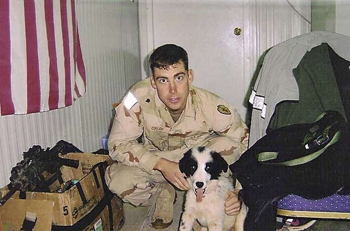 Emmet Cullen at Forward Operating Base Freedom in Mosul last year with the dog the platton adopted.