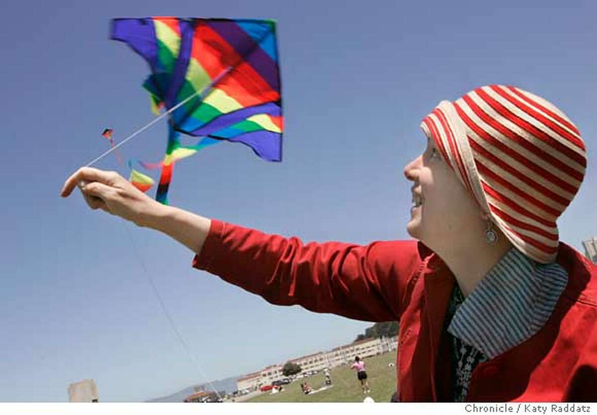 This weekend people all over America and around the world will fly kites in solidarity with thousands of Israeli and Palestinian citizens who want peace and want to reach out to one another in an actin called 10,000 Kites--Talking Kites. SHOWN: In San Francisco, at the Marina Green, many people flew kites. Leila Abu-Saba, a Lebanese woman who lives in Oakland, (she wears striped hat), launches her son's kite. Leila said: "So much of what divides us are walls and borders. Kites can fly above them." Photo taken on 5/22/05, in SAN FRANCISCO, CA. By Katy Raddatz / The San Francisco Chronicle