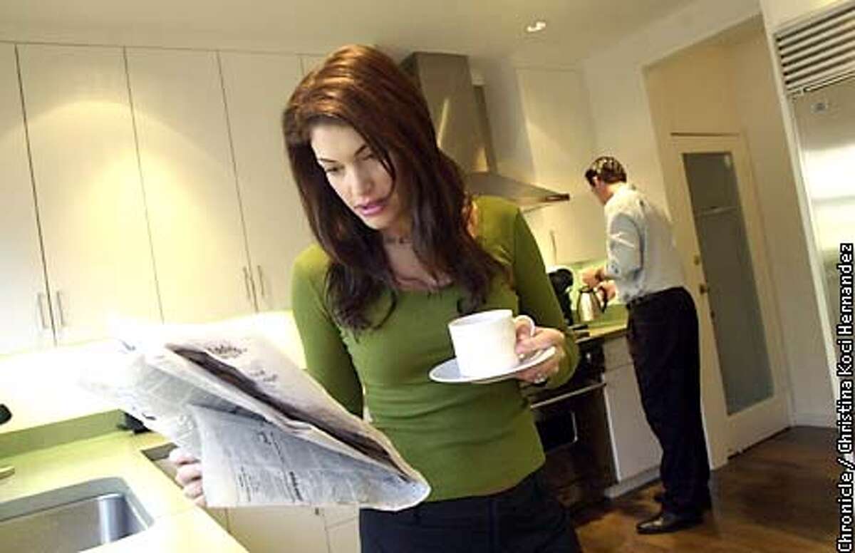 CHRISTINA KOCI HERNANDEZ/CHRONICLE Kimberly reads paper in the morning with Gavin in the kitchen.Gavin Newsom at home with wife, Kimberly Guilfoyle Newsom.