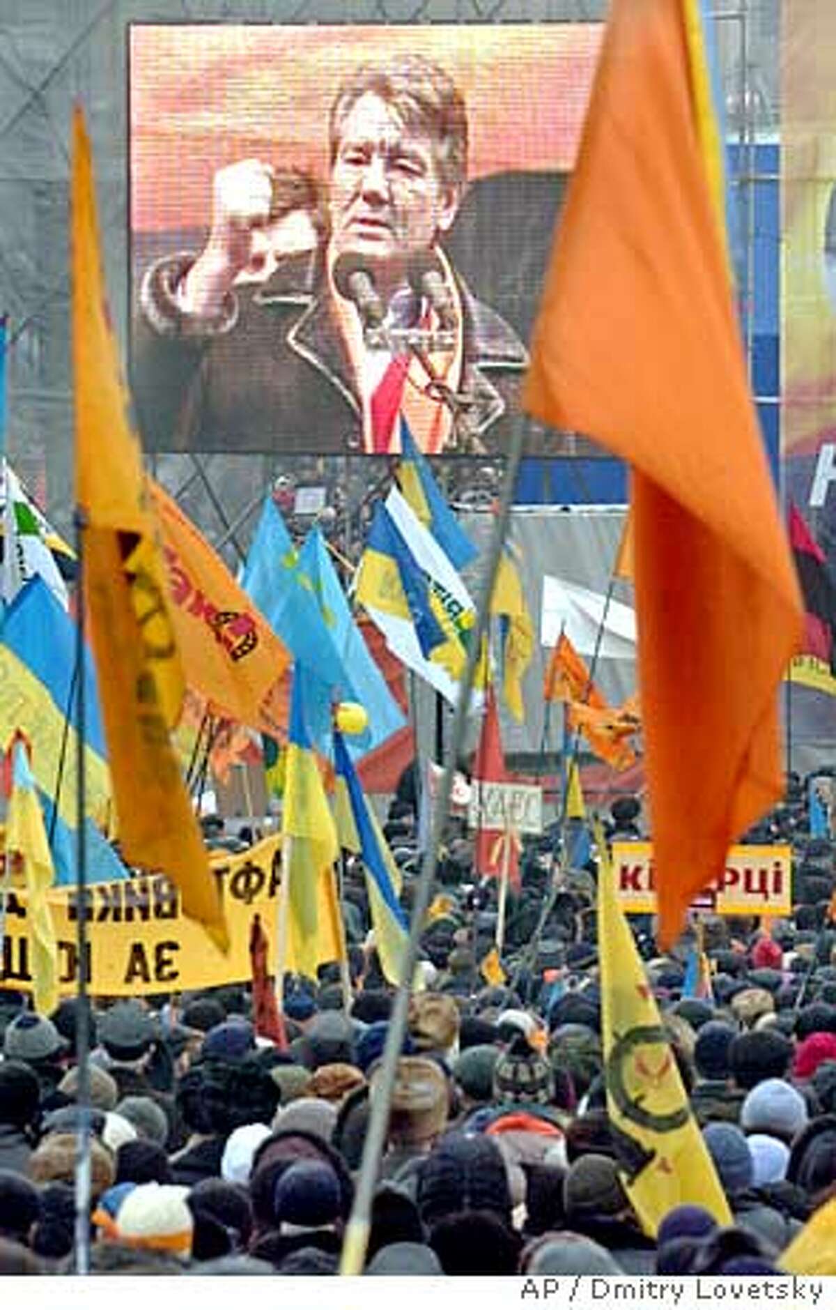 Opposition presidential candidate Viktor Yushchenko supporters watch a huge TV screen showing him speaking during a mass rally in downtown, Kiev, Sunday, Nov. 28, 2004, with various national flags and campaigne posters with orange Yushchenko flags. Yushchenko, who claims he was cheated out of victory in the Nov. 21 run-off election, is demanding a new vote. Hundreds of thousands of demonstrators have jammed downtown Kiev for a week to support him. (AP Photo/Dmitry Lovetsky) Ran on: 11-29-2004 Supporters of opposition leader Viktor Yushchenko rally near the Ukrainian parliament in Kiev. Ran on: 11-29-2004 Supporters of opposition leader Viktor Yushchenko rally near the Ukrainian parliament in Kiev.