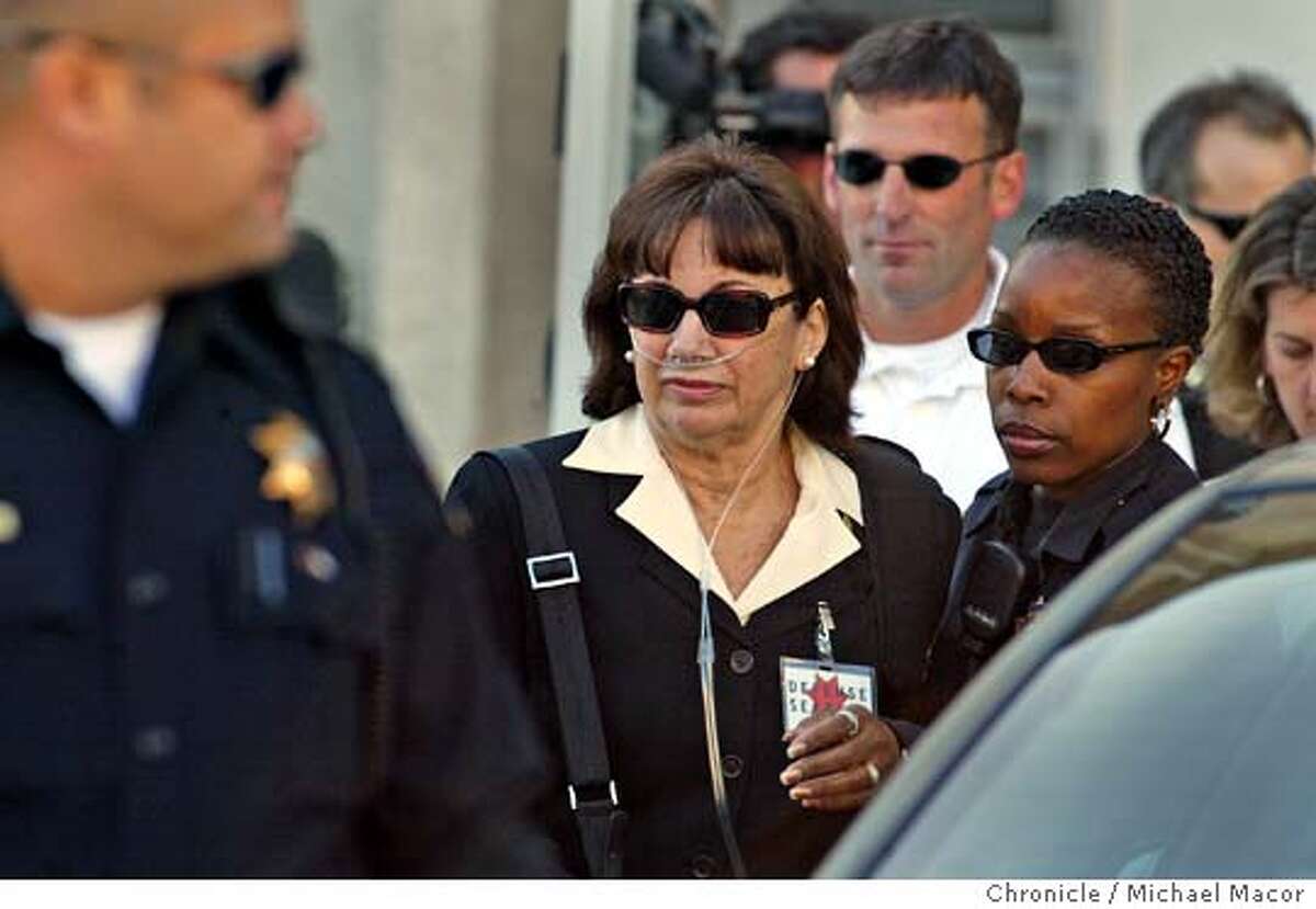 Scott Peterson's mother, Jackie Peterson is escorted by police officers to a waiting car following the reading of the verdict. San Mateo County Jury finds Peterson guilty. Scott Peterson found guilty in the murder of his wife and unborn son. 11/12/04 Redwood City, CA Michael Macor / San Francisco Chronicle
