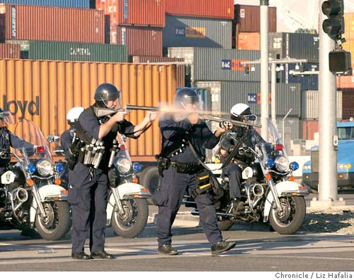 About 200 protesters blocked the entrances to three businesses at the Port of Oakland this morning. Oakland police arrived with bean bag rounds, sting balls, wooden dowels. (PHOTOGRAPHED BY LIZ HAFALIA/THE SAN FRANCISCO CHRONICLE)