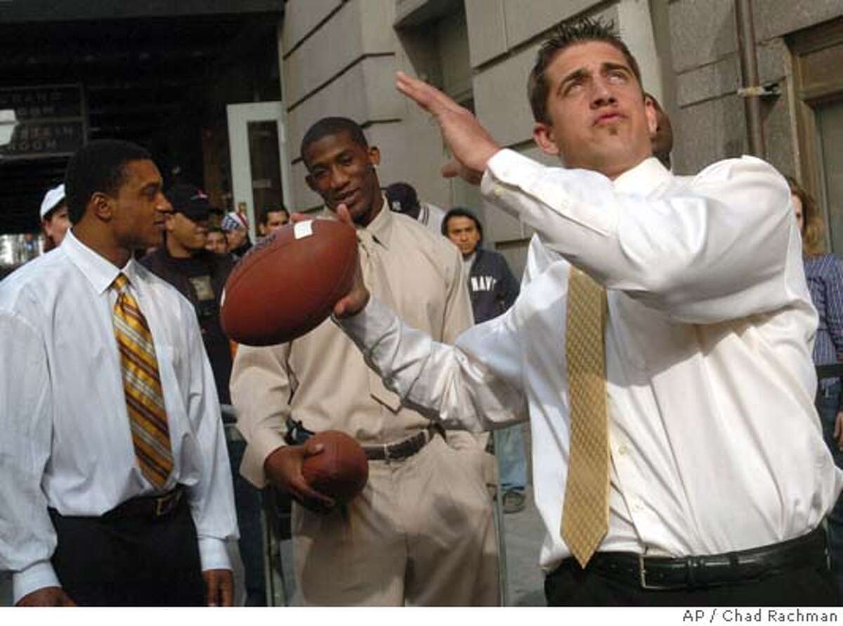 Utah quarterback Alex Smith, left, holds up a San Francisco 49ers jersey  with NFL commissioner Paul Tagliabue after the 49ers selected him as the  No. 1 overall pick in the NFL Draft