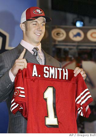 Utah quarterback Alex Smith, left, holds up a San Francisco 49ers jersey  with NFL commissioner Paul Tagliabue after the 49ers selected him as the  No. 1 overall pick in the NFL Draft