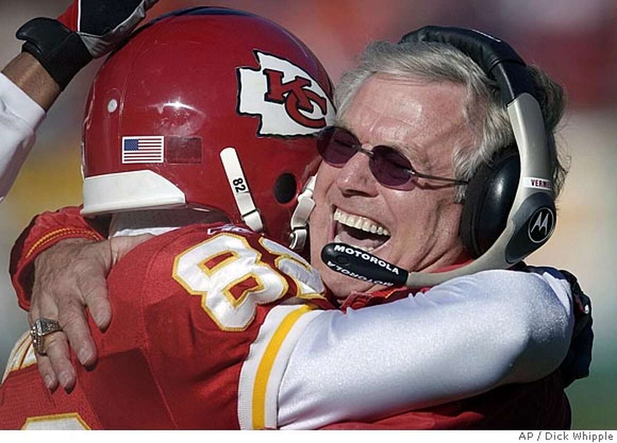 ** FILE ** Kansas City Chiefs coach Dick Vermeil, right, celebrates with Dante Hall (82) during the first quarter of their game against the Arizona Cardinals Sunday, Dec. 1, 2002, in Kansas City, Mo. The oldest coach in the National Football League figures staying around young people is the best way to stay young. ``It's true,'' said 67-year-old Dick Vermeil. ``My football team energizes me.''(AP Photo/Dick Whipple) ProductNameChronicle