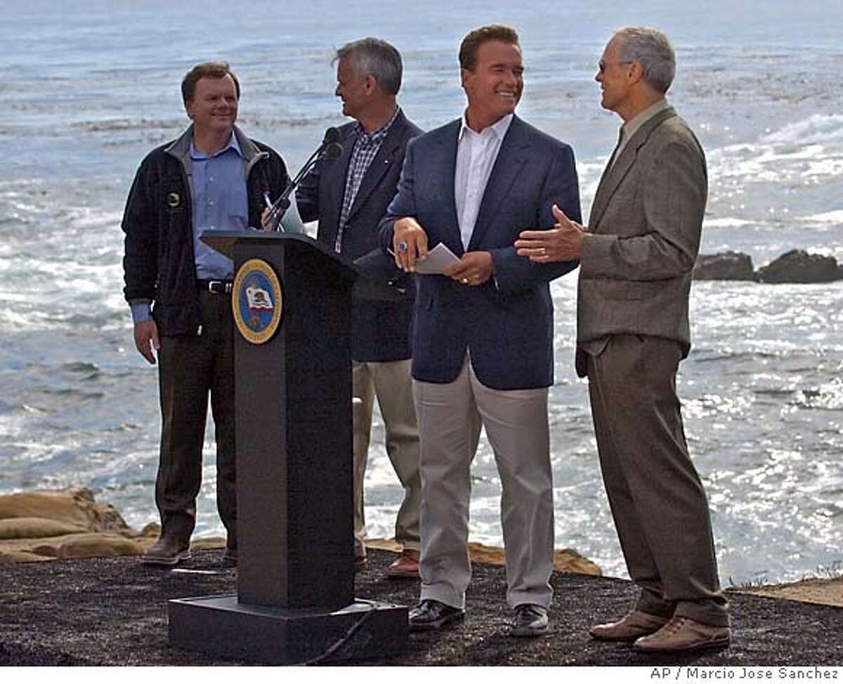 California Governor Arnold Schwarzenegger, second from right, is joined by , from left, State EPA secretary Terry Tamminen, Resource Agency Director, Mike Christman and actor Clint Eastwood, in announcing an ocean protection plan at Point Lobos State Park near Carmel, Calif. on Monday, Oct. 18, 2004. (AP Photo/Marcio Jose Sanchez)