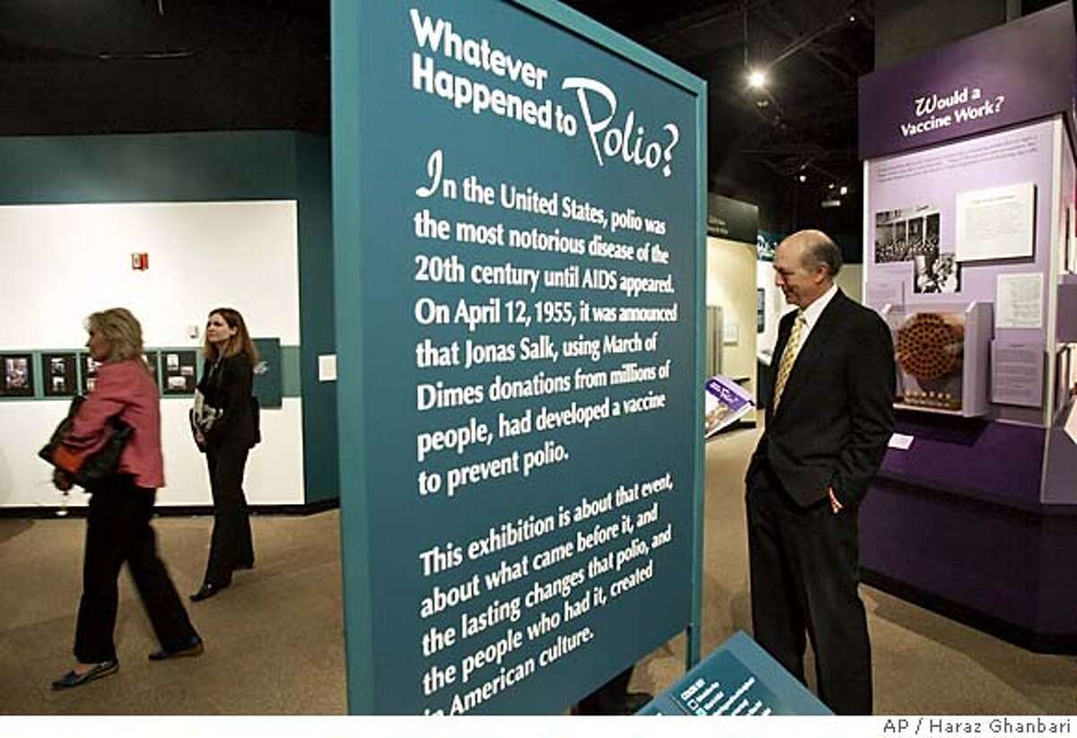 Dr. Jonathan D. Salk, right, son of Dr. Jonas Salk, walks through a new polio exhibit, Monday, April 11, 2005 at the Smithsonian's National Museum of American History in Washington. With an exhibit called the "Whatever Happened to Polio?," the museum marked the 50th anniversary of Jonas Salk's introduction of a successful polio vaccinationOthers are unidentified. (AP Photo/Haraz Ghanbari)