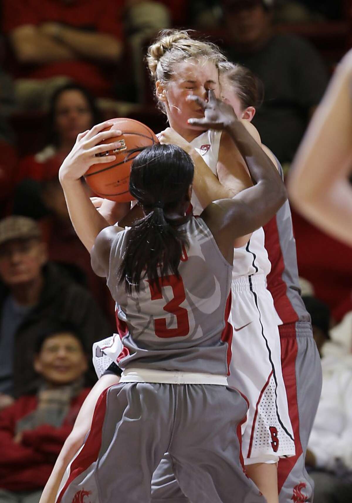 Stanford forward Joslyn Tinkle, top, is fouled by Washington State guard Rosetta Adzasu (3) in the first half of an NCAA college basketball game in Stanford, Calif., Thursday, Jan. 19, 2012. (AP Photo/Paul Sakuma)