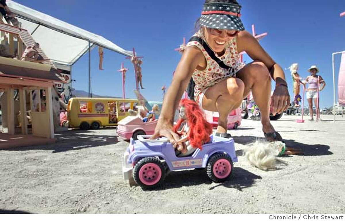 Yasmin Ward, 30, of Kauai drags a Barbie doll at the Barbie Death Camp and Wine Bistro on the playa at Burning Man 2005, Tuesday, August 30, 2005 in the Black Rock desert. burnman2005 Chris Stewart / The Chronicle