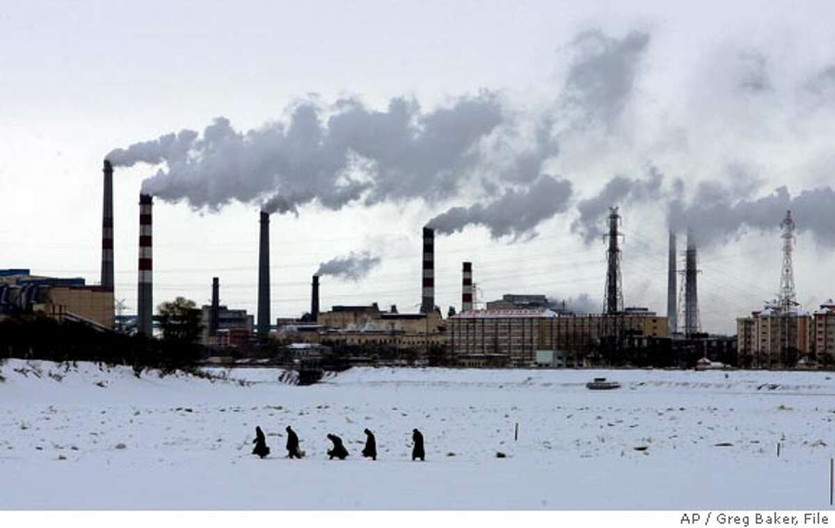 ** FILE ** Residents walk across the frozen Songhua River in front of smoke stacks at Jiamusi, in China's northeast Heilongjiang province in this Dec. 4, 2005 file photo. China is concerned about global warming but lacks the money and technology to significantly reduce its own greenhouse gas emissions that are worsening the problem, a top government scientist said Tuesday, Feb. 6, 2007. (AP Photo/Greg Baker, File) Ran on: 03-05-2007 Residents walk across the ice-covered Songhua River in front of smoke stacks at Jiamusi, in Heilongjiang province. China lacks the technology to reduce its emissions. Ran on: 03-05-2007 Residents walk across the ice-covered Songhua River in front of smokestacks at Jiamusi, in Heilongjiang province. China lacks the technology to reduce its emissions.