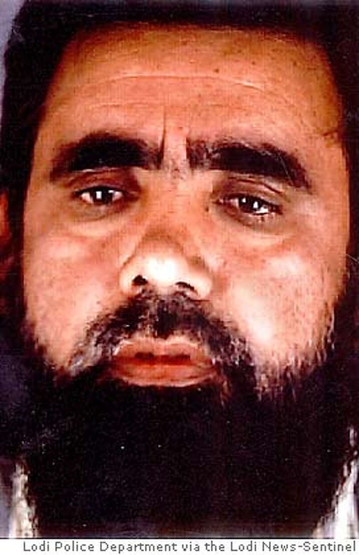 ** FILE ** This is an undated photo of Umer Hayat provided by the Lodi (Calif.) Police Department. Hayat, 47, was indicted on a single count of lying to investigators when he denied that his son had attended training camps connected to al-Qaida. Hayat later admitted flying his son to Pakistan and paying for the camp, which was run by the friend of a relative. U.S. District Judge Garland E. Burrell Jr. on Friday, July 1, 2005, set the trial for Aug. 23 and placed the burden on the government to prove why the two men should not be tried quickly. (AP Photo/Lodi Police Department via the Lodi News-Sentinel)