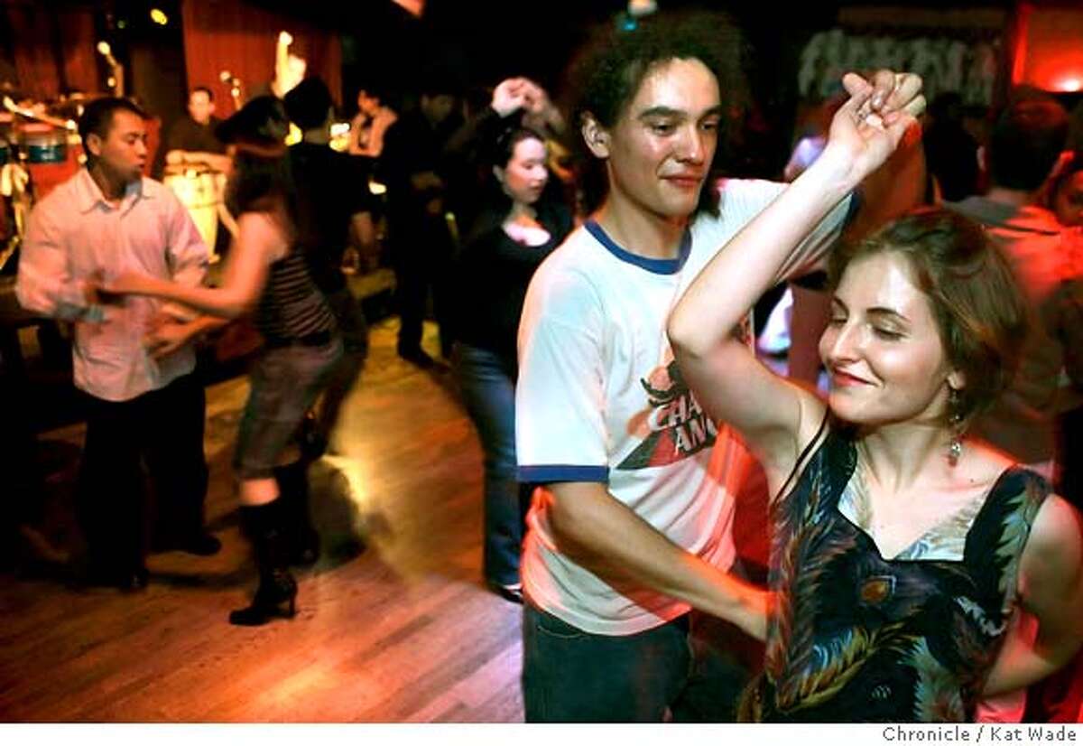 DOWNLOW_108_KW.jpg (RIGHT SIDE) L to R: Christopher Tafoya and Jessica Kirkpatrick dance to the live music of the band 'La Verdad' on Salsa night at the Shattuck Down Low Lounge in Berkeley on Wednesday February 21, 2007. Kat Wade/The Chronicle Christopher Tafoya and Jessica Kirkpatrick (CQ, subjects) Mandatory Credit for San Francisco Chronicle and photographer, Kat Wade, No Sales Mags out