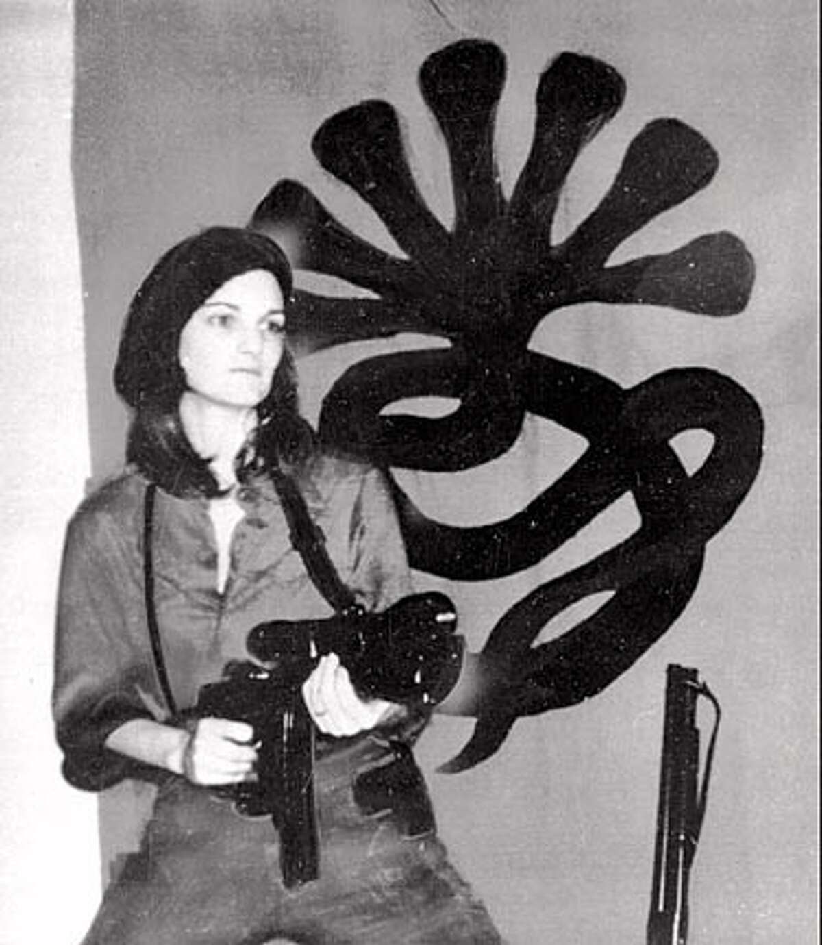 FILE--This is a photo that was received by a San Francisco radio station in April 1974 showing Patty Hearst in front of a SLA Symbionese Liberation Army insignia and holding what was described as an automatic weapon. She was calling herself TANYA as a SLA member. Friday, February 4, marks the 20th anniversary of Patty Hearst's kidnapping. (AP Photo/File) also ran: 10/07/00 CAT BookReview#BookReview#Chronicle#08-21-2005#ALL#2star#e4#0421815545