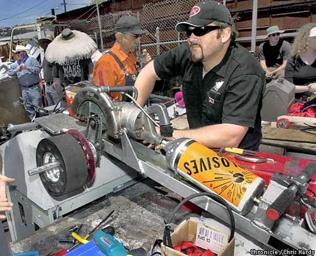 Power Tool Drag Races! Just what it sounds like. Gearhead creative types gather to show off their bastardized, custom-retrofitted power tools. Sponsored by a group called QBox, a nonprofit that specializes in "kinetic" art (robots and mechanical contraptions). Part of a larger piece on the recent proliferation of electronic and mechanical art -- the Robot Wars craze, for instance. 5/11/03 in San Francisco. CHRIS HARDY / The Chronicle