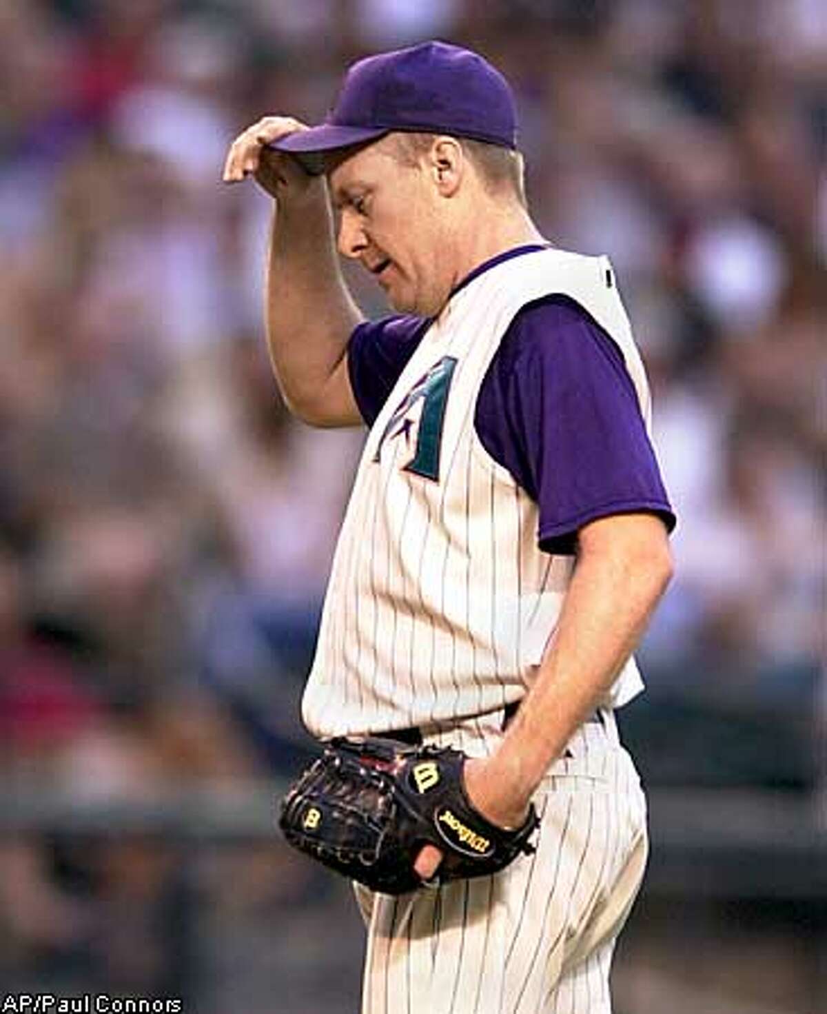 Arizona Diamondbacks pitcher Curt Schilling reacts after giving up a homerun to San Francisco Giants batter J.T. Snow in the second inning Monday, May 19, 2003, in Phoenix. Schilling gave up two homeruns in the inning.(AP Photo/Paul Connors)