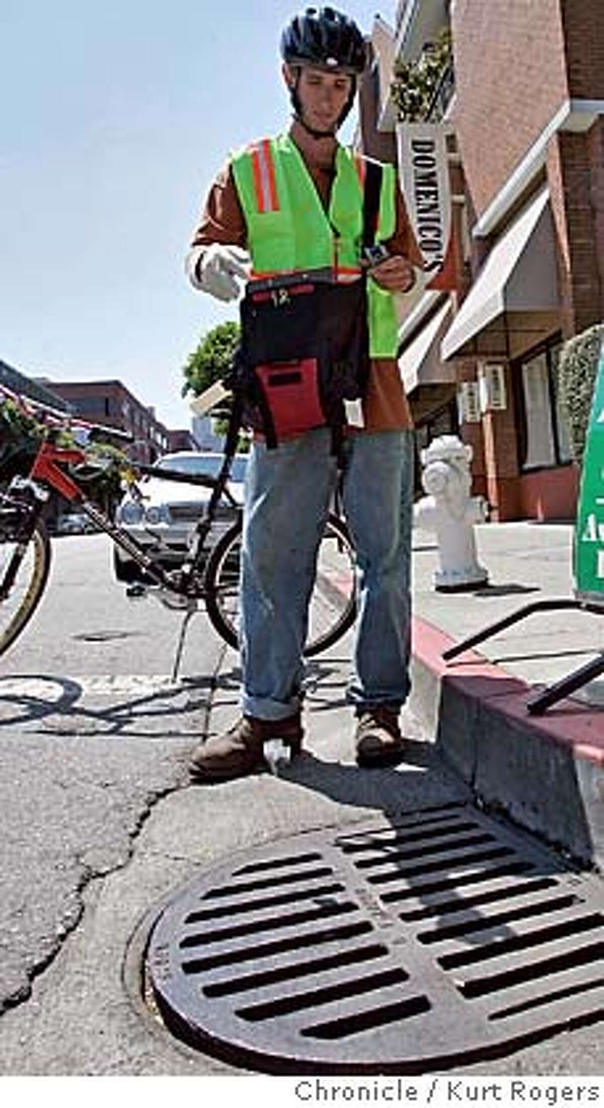 Jim Henning 24 of San Francisco who was hired to be a bike messenger to do mosquito abatement in San Francisco. droups a bag of Altosid pellets into the storm drane at Lombard and Sansome. A day after SF identifies its first-ever case of West Nile virus, a fleet of bike messengers is being dispatched to catch basins throughout San Francisco equipped with Nextel phones with GPS satellite capabilities along with non-toxic abatement pellets that prevent mosquitoes from maturing. It's an alternative to spraying. Agency coordinating it is the Dept. of Environment. WESTNILE_0115_kr.JPG 8/16/05 in San Francisco,CA. KURT ROGERS/THE CHRONICLE MANDATORY CREDIT FOR PHOTOG AND SF CHRONICLE/ -MAGS OUT