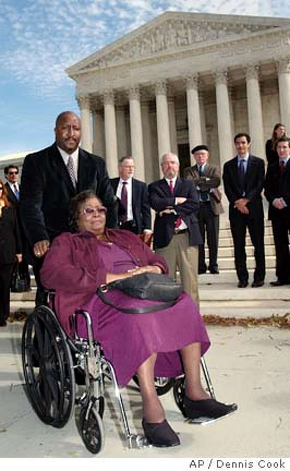 **FILE** Mayola Williams, in wheelchair, widow of Jesse Williams, who died of lung cancer, leaves the Supreme Court in Washington in this Oct. 31, 2006 file photo, following oral arguments in her lawsuit against Philip Morris. The Supreme Court threw out a $79.5 million punitive damages award to Williams, Tuesday, Feb. 20, 2007, a boon to businesses seeking stricter limits on big-dollar jury verdicts. (AP Photo/Dennis Cook, file)
