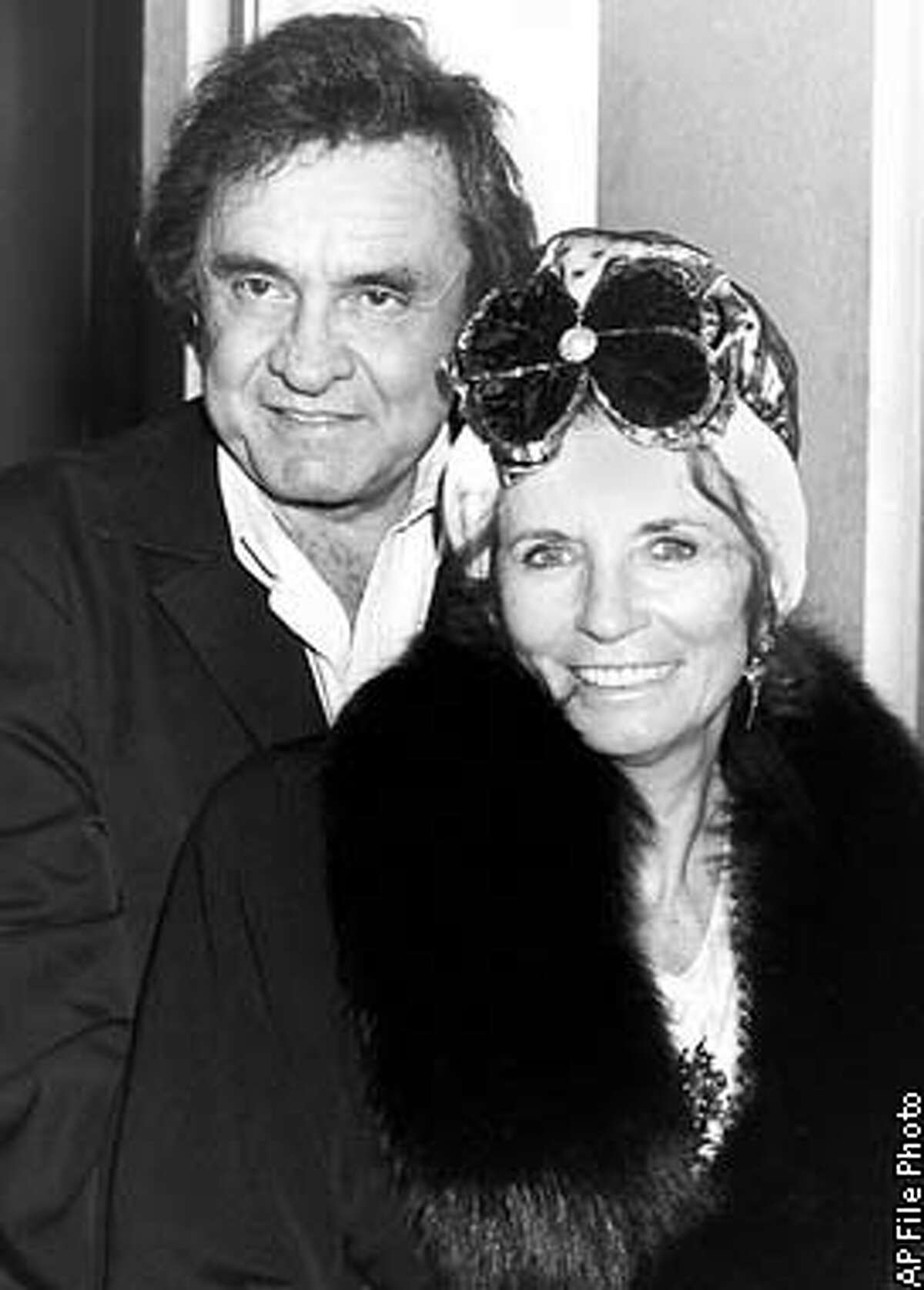 **FILE** June Carter Cash, is seen with her husband, country music legend Johny Cash in London in this April 29, 1988 file photo. June Carter Cash, the Grammy-winning scion of one of country music's pioneering families and the wife of country giant Johnny Cash, died Thursday, May 15, 2003 of complications from heart surgery. She was 73. (AP Photo/ File)
