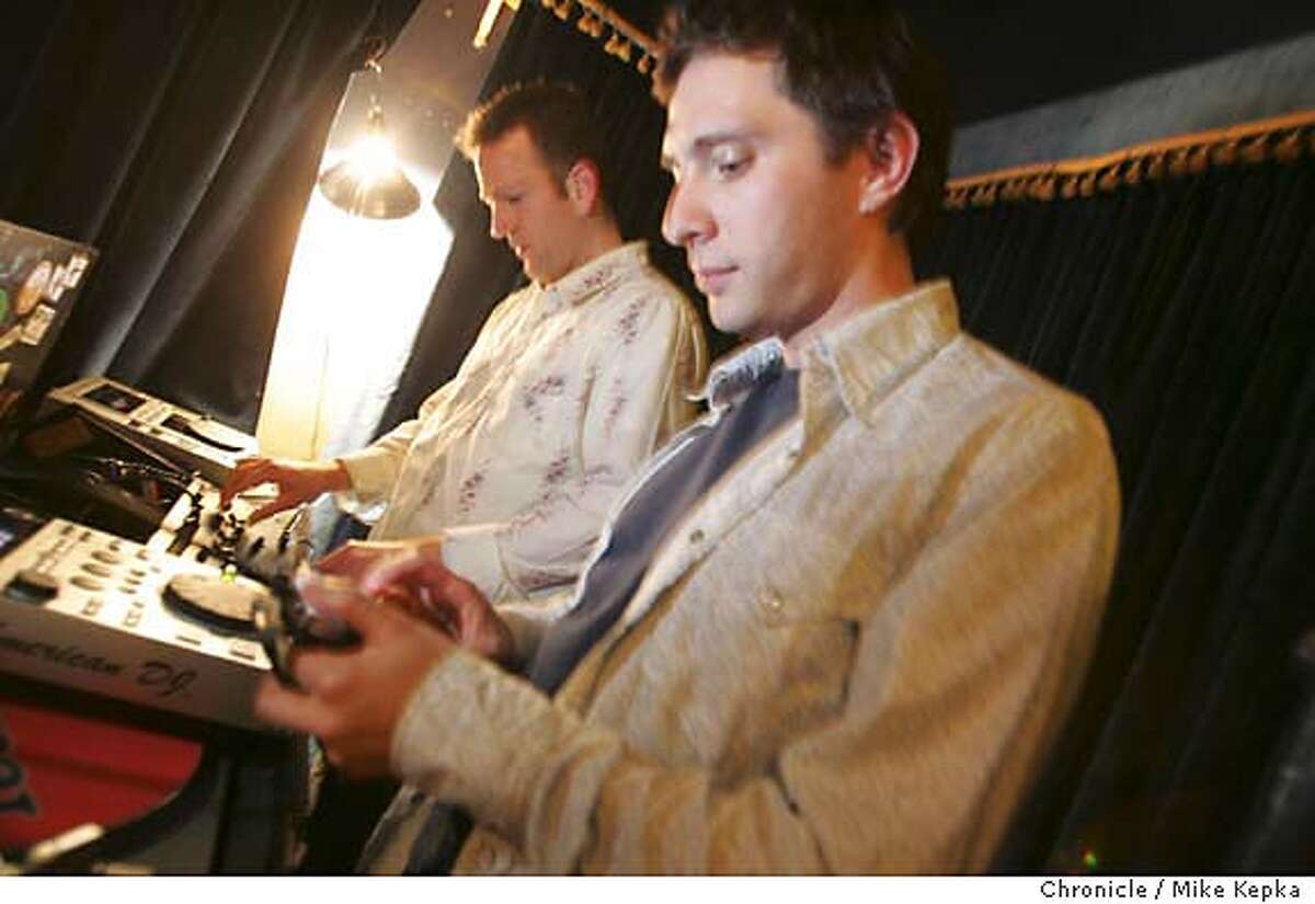 Indie spinners try their hand at the clickwheel inside the Hush Hush Lounge on a Wednesday night. 7/12/05 Mike Kepka / The Chronicle