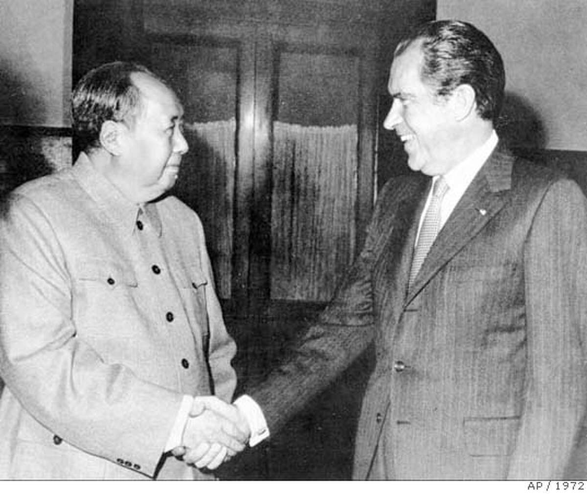 FILE--Richard Nixon died Friday, April 22, 1994 four days after suffering a major stroke, according to a New York Hospital spokesman. He was 81. President Richard Nixon shakes the hand of Chairman Mao Tse-tung during Nixon's historic visit to China on Feb. 1972. (AP Photo/Files) A 1972 FILE PHOTO Ran on: 06-13-2004 Princess Diana talks to amputees near Luanda, capital of Angola. In death, she was remembered for her crusade to ban the use of land mines. CAT