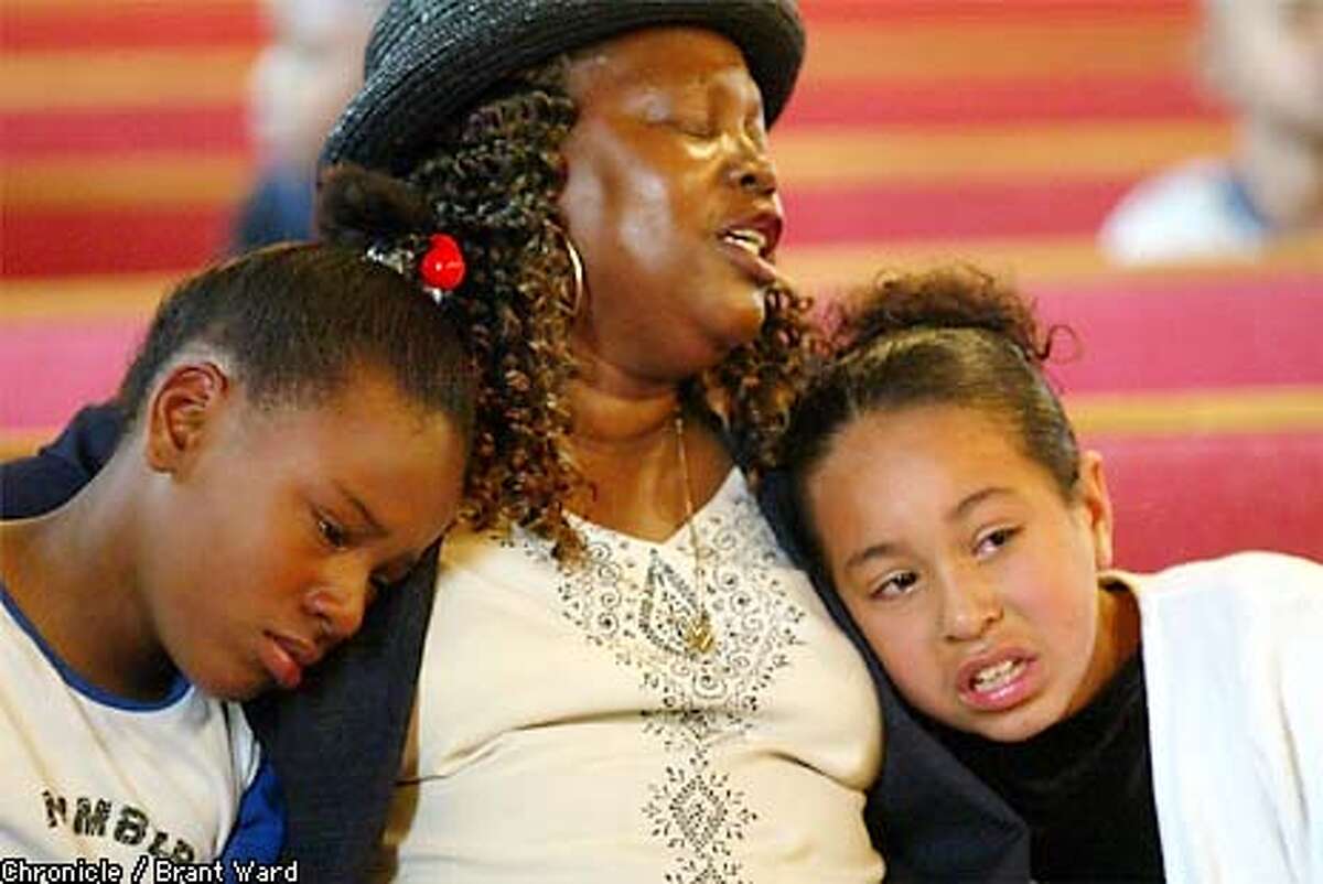The funeral for Julia Middleton--better known as Aunt Bea--was held Thursday at St. John Baptist Missionary Church on Third Street in San Francisco. Children and adults alike, whom she touched during her time in Hunters Point, turned out to remember and say goodbye. Here Naeshante Joshua, left, and Sandra Rodriguez sought comfort in the arms of their choir teacher Tessa (no last name given) as they were caught up in the emotion of their beloved Aunt Bea's memorial. BRANT WARD / The Chronicle