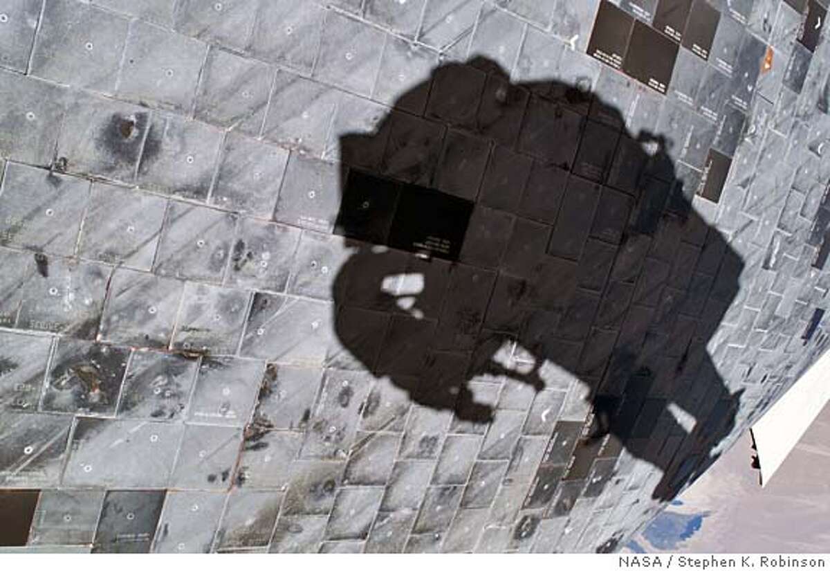 In this photo provided by NASA, a close-up view of a portion of space shuttle Discoverys underside is featured in this image photographed by astronaut Stephen K. Robinson, Discovery mission specialist, during the missions third session of extravehicular activities (EVA), Wednesday Aug. 3, 2005. Robinsons shadow is visible on the thermal protection tiles. (AP Photo/NASA, Stephen K. Robinson) NASA IMAGE TAKEN WEDNESDAY AUG. 3, 2005 MADE AVAILABLE THURSDAY AUG. 4, 2005