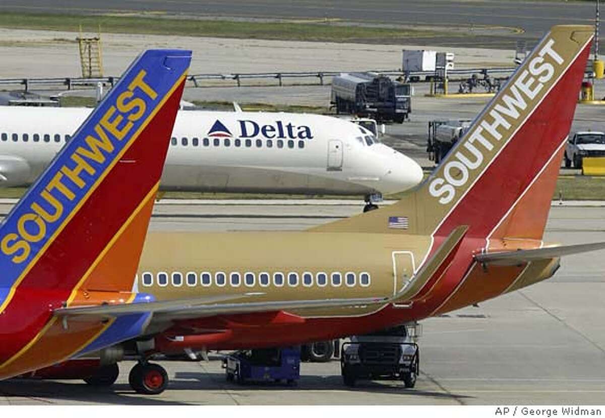 Two Southwest Airlines jets are seen in front of a taxiing Delta jet at Philadelphia International Airport Thursday, Sept. 23, 2004. Low-cost carrier Southwest Airlines Inc. on Thursday, April 14, 2005, said first-quarter earnings nearly tripled, citing higher traffic in March, cost cutting and successful financial management of fuel costs.(AP Photo/George Widman) Ran on: 04-15-2005 Photo caption SEPT. 23, 2004, PHOTO