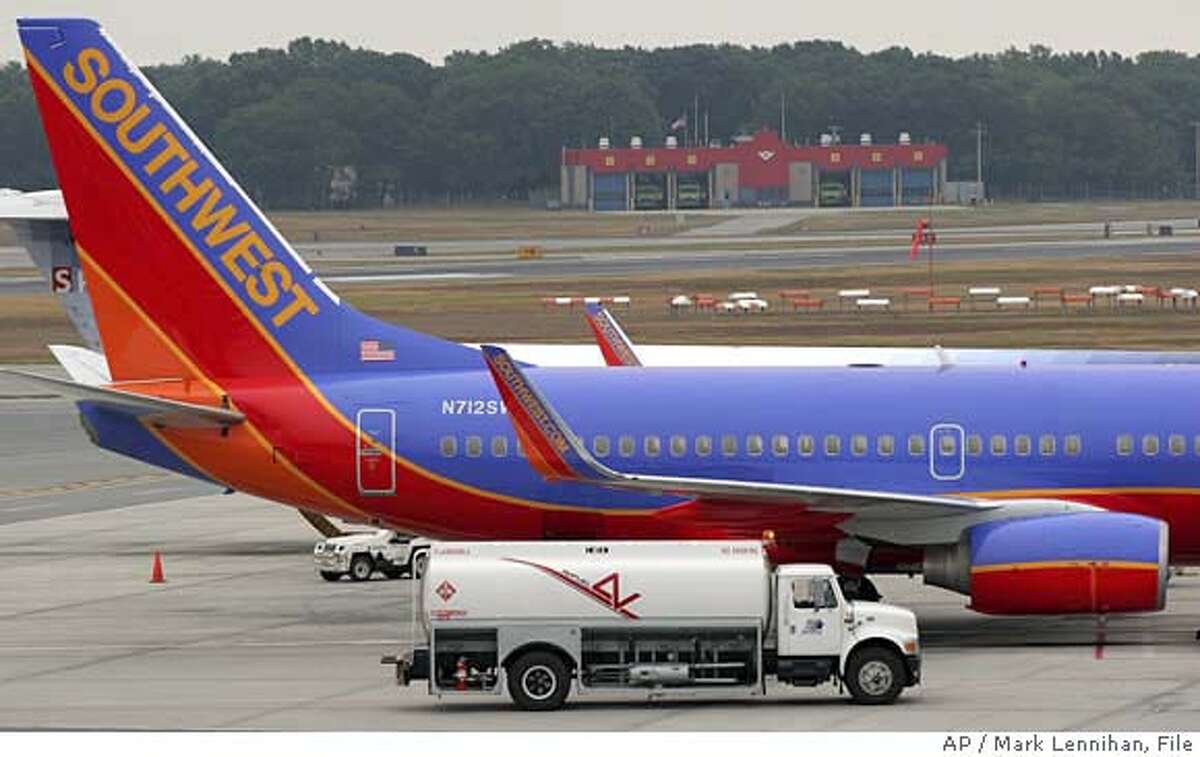 A Southwest Airlines jet is refueled at J.F. Green Airport in Warwick, R.I. Sunday, Aug. 21, 2005. Southwest Airlines Co. has joined the parade of carriers that are raising fares to help cover the rising cost of jet fuel. Retail gasoline prices are poised to jump to new highs this week as Hurricane Katrina barreled toward the heart of U.S. oil production and refining operations in the Gulf of Mexico on Monday, Aug. 29, 2005 sending crude-oil futures briefly above $70 a barrel for the first time. (AP Photo/Mark Lennihan)Ran on: 03-10-2006 Southwest Airlines and other low-cost carriers are being forced by rising fuel prices to raise their fares and limit deals.