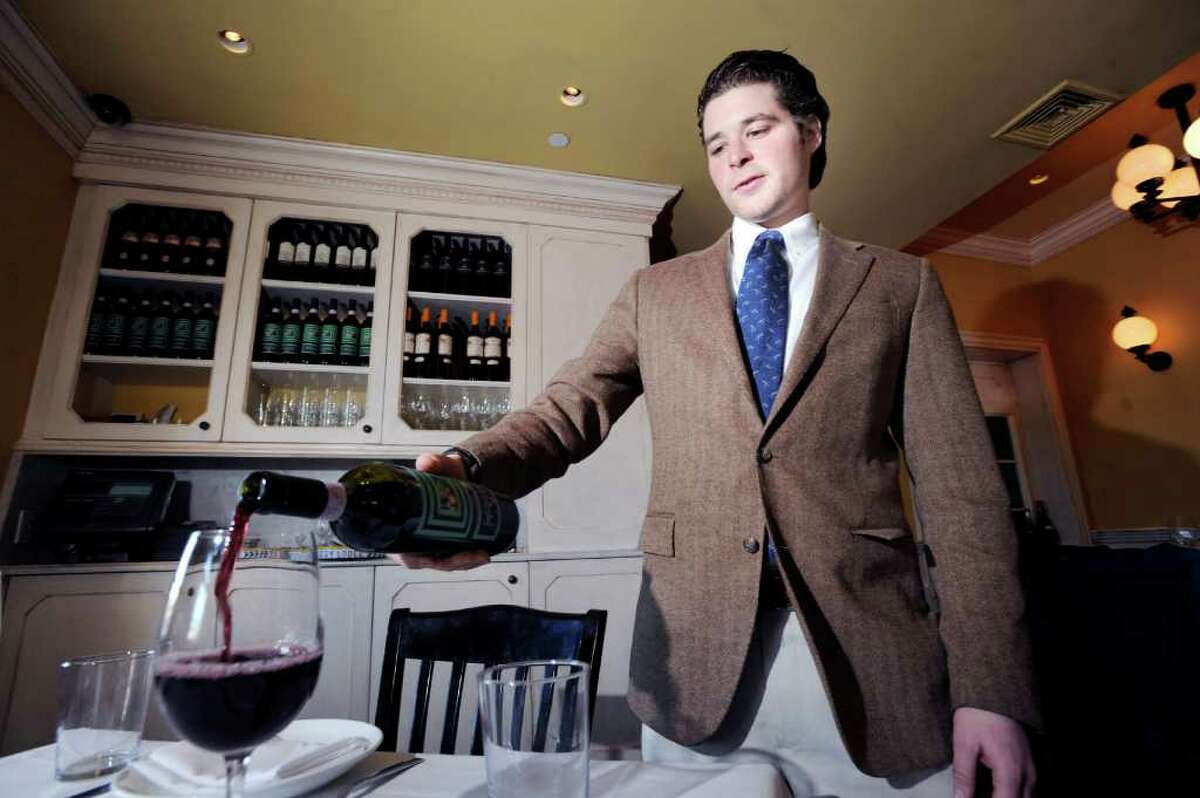 Chase Hochstin of Greenwich, sommelier for Tarry Lodge, pours a red wine in the Port Chester, N.Y., restaurant, Friday, Jan. 20, 2012.