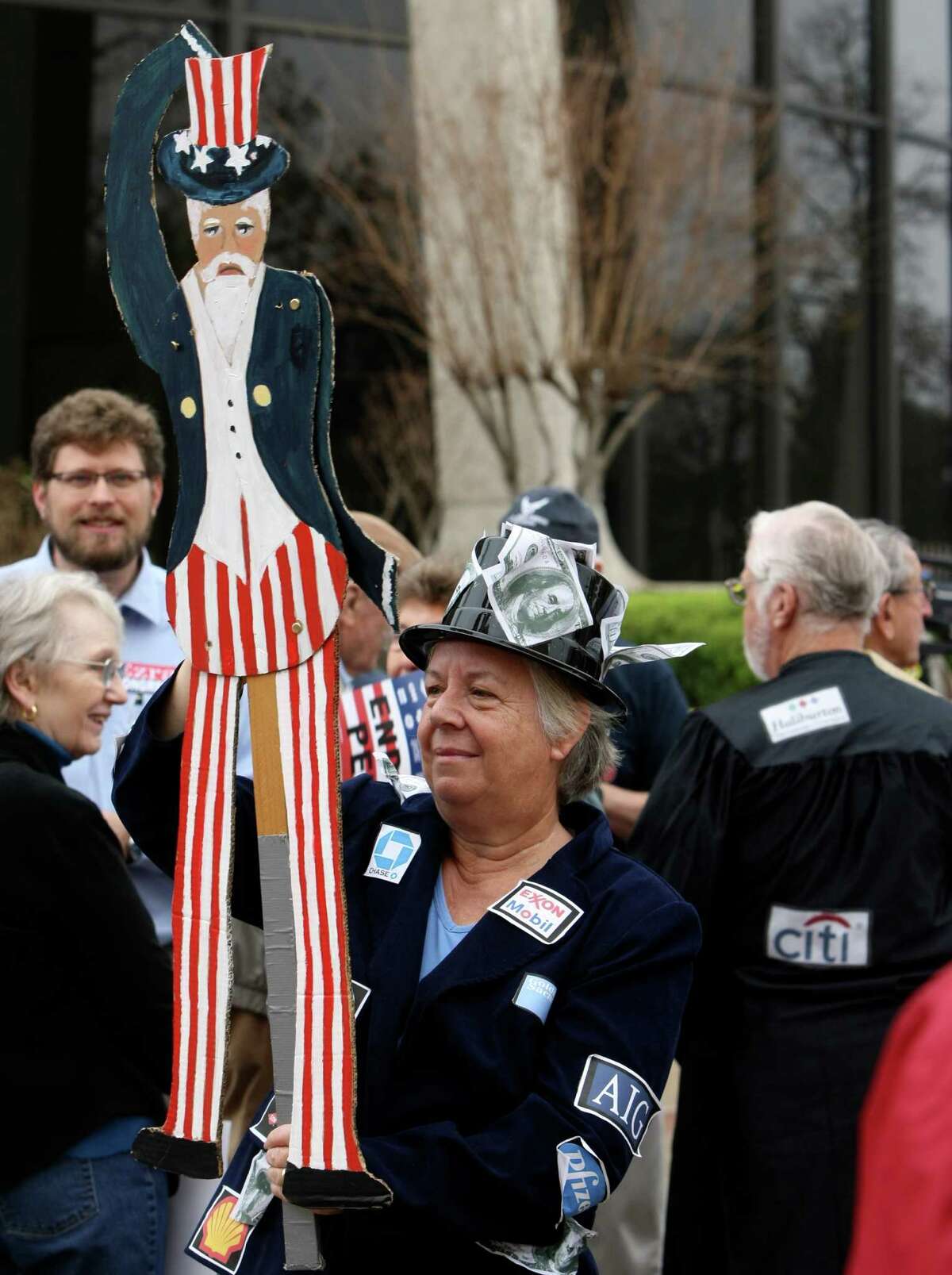METRO: Vibeke Lee holds an Uncle Sam puppet during a protest by the group Move to Amend staged on Friday Jan 20, 2012 to rally for overturning the Supreme Court's majority decision of Citizens United v. Federal Election Commission responsible for the flood of anonymous dollars now usurping our political process with untraceable corporate dollars and to get more organized. Helen L. Montoya/San Antonio Express-News