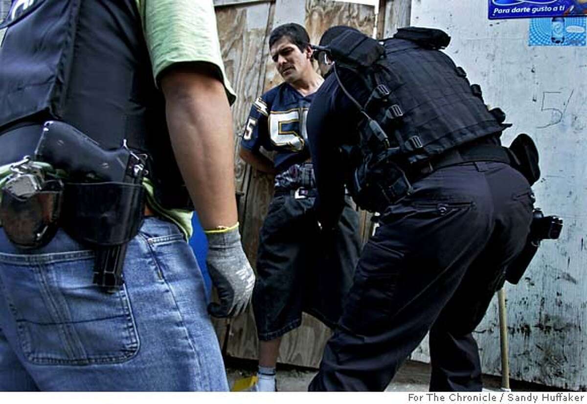 Tijuana Police agents search a man for illegal contraband during a drug sweep in Colonia Chula Vista on Thursday, December 14, 2006 in Tijuana, Mexico.(Photo by Sandy Huffaker for the SF Chronicle)