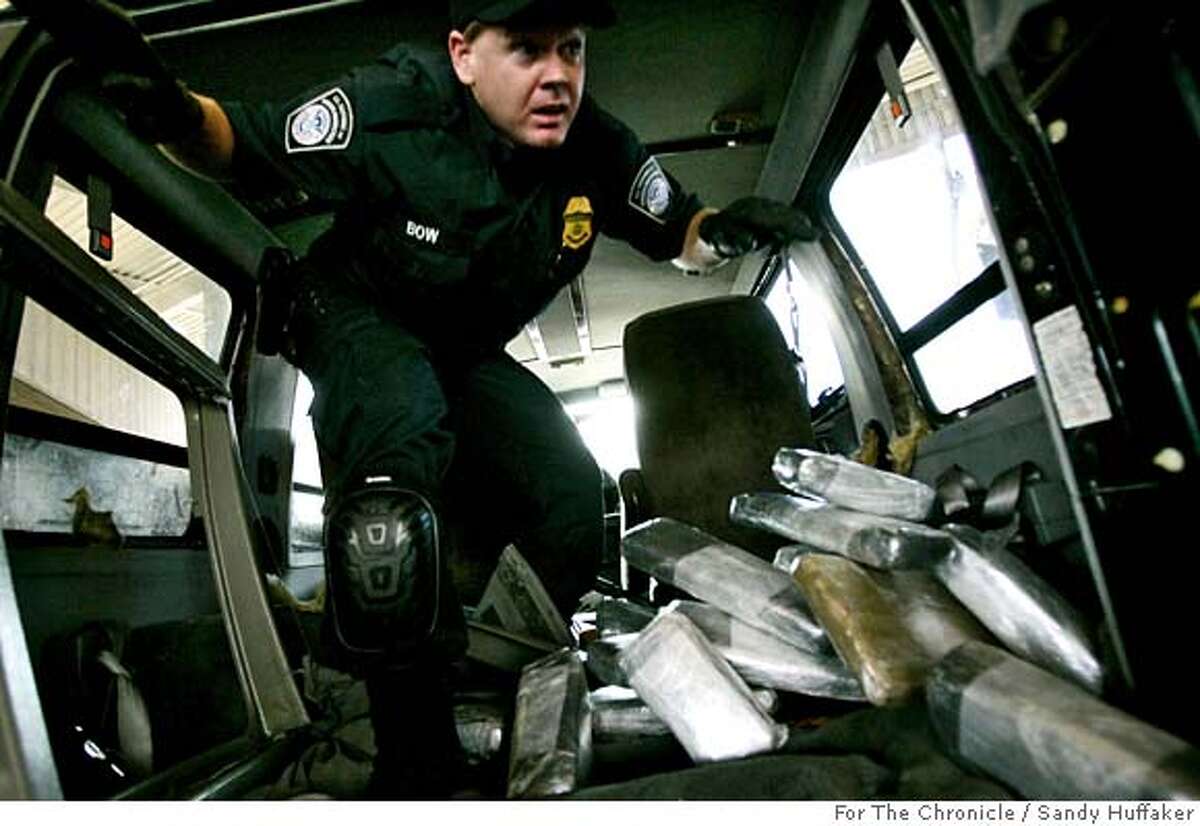 Customs and Border Protection agent Ian Bow exits a van after pulling out bricks of Marijuana at the U.S. Port of Entry in San Ysidro, Calif. on Friday, December 15, 2006. The drugs were concealed throughout the van behind wall paneling and in a chamber in the gas tank.(Photo by Sandy Huffaker for the SF Chronicle)