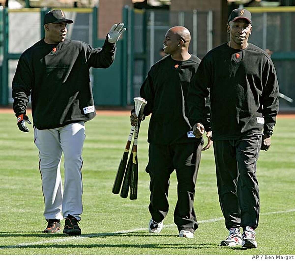 San Francisco Giants' Barry Bonds, left, gestures beside trainers Greg Oliver, center, and Harvey Shields during a Major League baseball spring training workout Wednesday, Feb. 22, 2006, in Scottsdale, Ariz. (AP Photo/Ben Margot) EFE OUT
